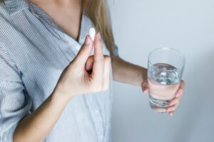How does paracetamol work to reduce fever and pain?